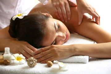 Obraz na płótnie Canvas Young woman on massage table in beauty spa salon