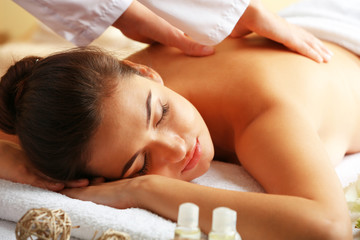 Fototapeta na wymiar Young woman on massage table in beauty spa salon