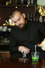 Bartender is pouring liquor into glass