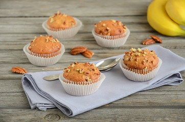 Homemade banana muffins with pecans on the wooden table