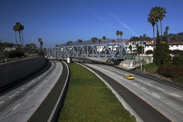 Yellow Corvette drives Route 101 at California Avenue, Ventura, California, USA, 01.29.2014