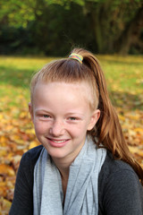 happy Girl in autumn park with leaves