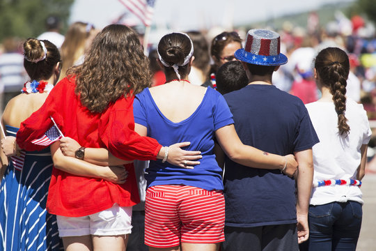 Backs of women pose for picture, July 4, Independence Day Parade, Telluride, Colorado, USA, 04.07.2014