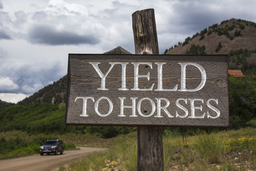 Fototapeta premium Road sign saying Yield to Horses, Colorado, USA, 04.07.2014
