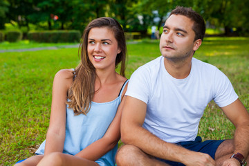 Pretty girl and her boyfriend are cuddling in park