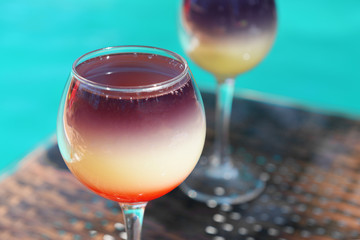 Cocktails on swimming pool background