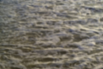 Wave breaking on tropical beach - blurred background