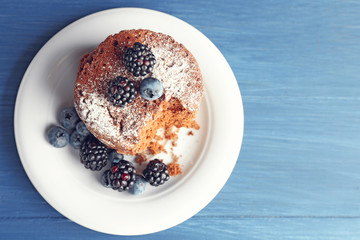 Cake with berries on wooden table