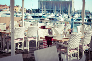 Restaurant's interior with beautiful sunny harbour view from big window