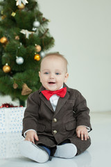 Small boy plays in white studio