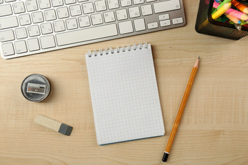White keyboard and notebook on the desk