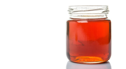 Maple syrup in a mason jar over white background