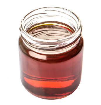 Maple Syrup In A Mason Jar Over White Background