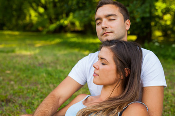 Couple fall asleep while picnic in park.