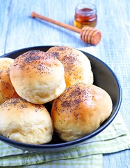homemade scones with poppy seeds and honey on wooden background