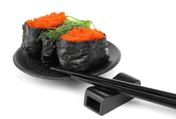 Sushi with tobiko and chopsticks isolated on white