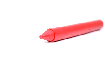 Red crayon on white background.