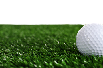 Golf ball on grass isolated on white