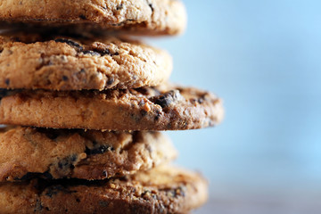 Close up focus view on cookies with chocolate crumbs on wooden table against blurred blue background