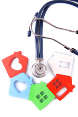 Concept of family medicine - colourful houses and stethoscope isolated on white background