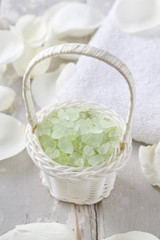 Sea salt in wicker baskets among white rose petals