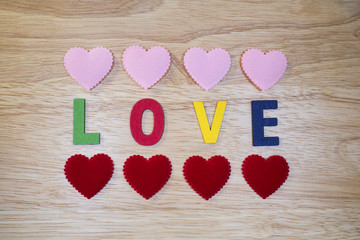 Word Love 4 - Colorful words "Love" made from wooden letters on wood background (Valentines day)