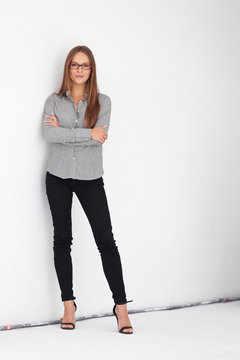 Portrait Of Beautiful Business Woman Standing Against White Wall