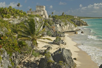 Mayan ruins of Ruinas de Tulum (Tulum Ruins) in Quintana Roo, Mexico. El Castillo is pictured in Mayan ruin in the Yucatan Peninsula, Mexico at sunset, with beach and Caribbean Sea to right