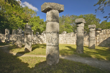 Fototapeta premium Columns surrounding grassy courtyard for ballgames at Chichen Itza, Mayan Ruins in the Yucatan Peninsula, Mexico