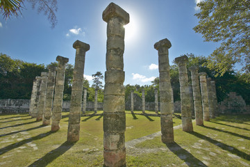 Fototapeta na wymiar Columns surrounding grassy courtyard for ballgames at Chichen Itza, Mayan Ruins in the Yucatan Peninsula, Mexico