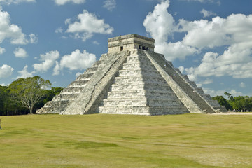Fototapeta na wymiar White puffy clouds over the Mayan Pyramid of Kukulkan (also known as El Castillo) and ruins at Chichen Itza, Yucatan Peninsula, Mexico