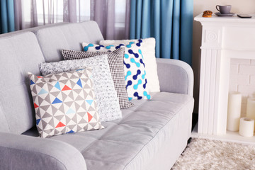Sofa with colorful pillows in room