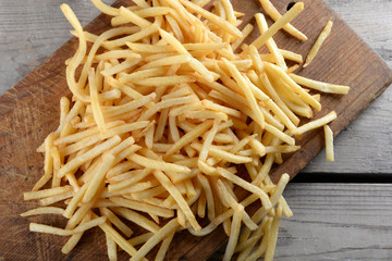 French fried potatoes on cutting board