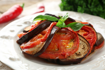 Ratatouille on plate, on table background