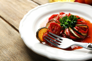 Ratatouille on plate, on table background