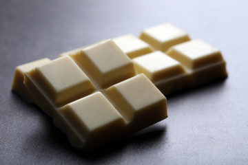 White chocolate pieces on gray background