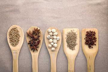 Various colorful spices in  wood spoon