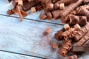 Chocolate sweets with powder on wooden background