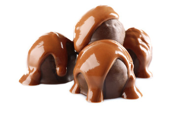 Chocolate poured on candy isolated on white