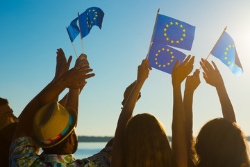 People with raised hands waving flags of the European Union.  - obrazy, fototapety, plakaty