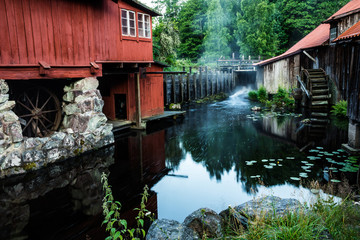 Fototapeta na wymiar historical buildings of old steelworks by stream