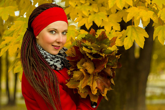 Fototapeta Woman with leaves in hairstyle with braids