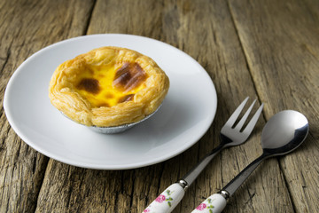 delicious portuguese egg tart on wood background