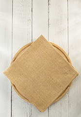 cloth napkin and cutting board on wood