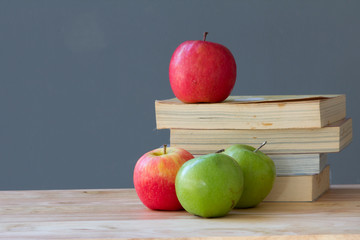 stack of books with apples