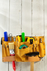 tools and instruments in belt on wood