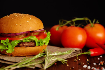 Burger with ripe lettuce, tomatoes and juicy cutlet of beef