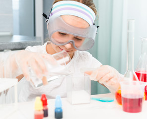 little girl with flasks for chemistry