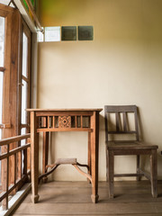 Window sunlight on antique wooden table and chair