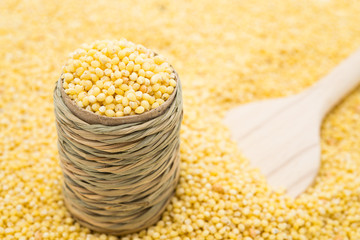 Millet in barrel with wooden spoon